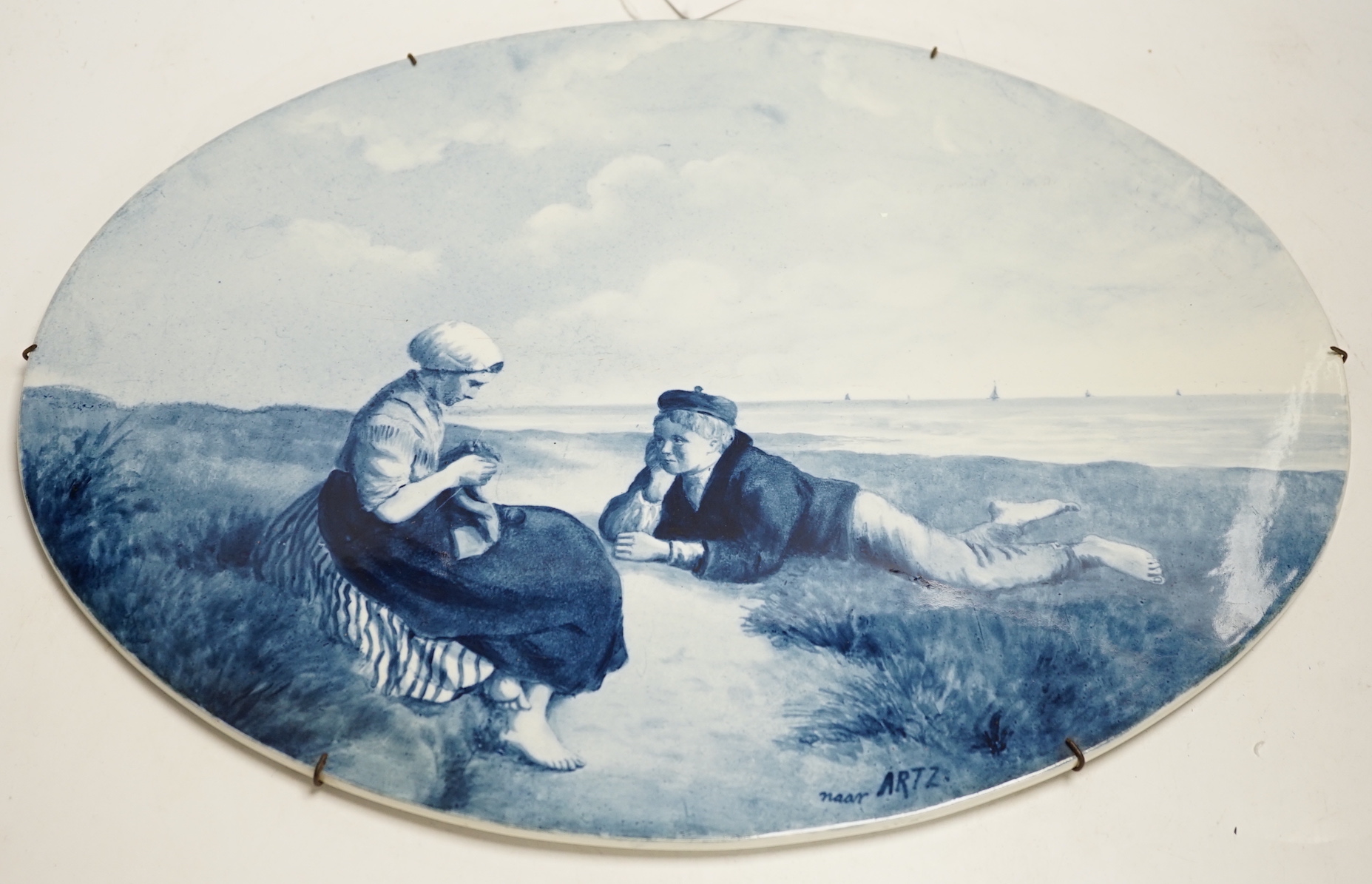Three late 19th/early 20th century Delft oval landscape plaques, 45cm